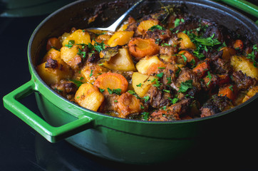 Baked potatoes with beef and prunes.