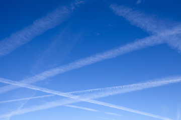 Fototapeta na wymiar Airplane Trails in the Blue Sky
