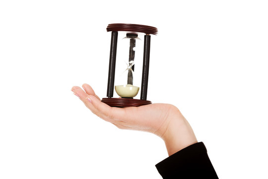 Young business woman holding hourglass-time concept