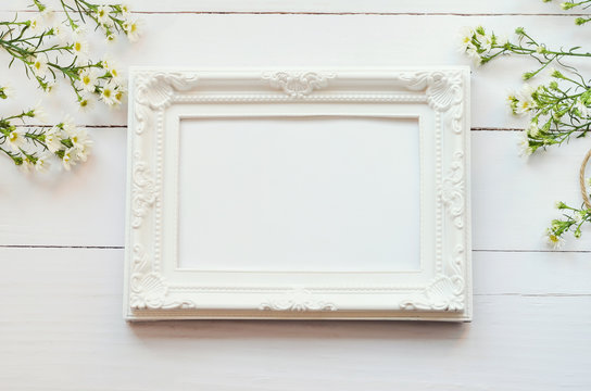 Vintage frame on white wooden background