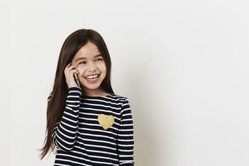 Young girl laughing on cell phone