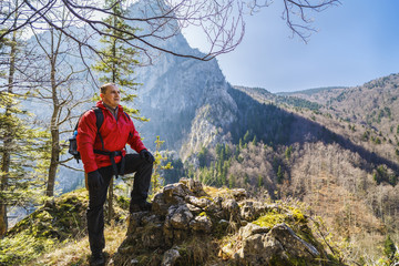 Man hiker enjoying the view on a mountain trail