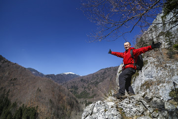 Man hiker enjoying the view on a mountain trail