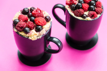 Mug Cakes with Berries Prepared in Microwave on Pink Funny Background, Horizontal View