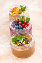Fototapeta na wymiar desserts with fresh berries, fruit and chocolate, vertical