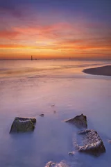 Tuinposter Beach with rocks at sunset in Zeeland, The Netherlands © sara_winter