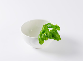 fresh basil in white bowl