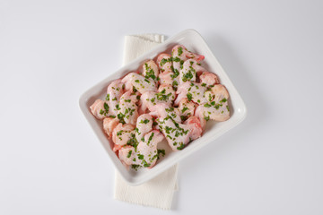 raw chicken wings in white baking dish