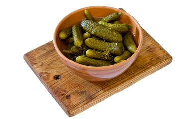 Pickled cucumbers gherkins in ceramic cup on a white background