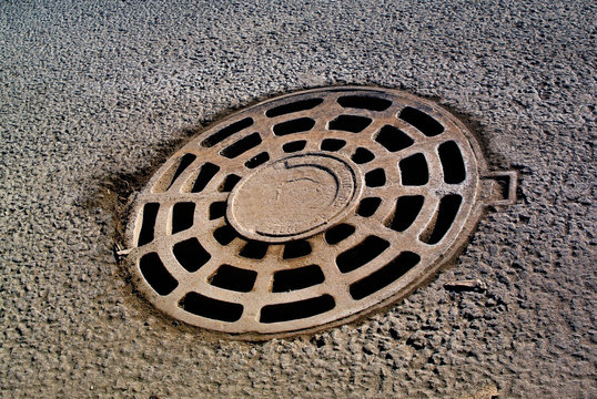 Sewer manhole on the city asphalt road