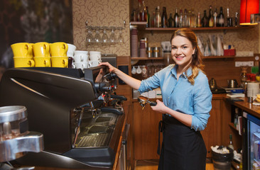 barista woman making coffee by machine at cafe