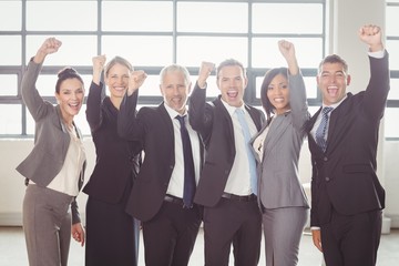 Businessman cheering with clenched fist