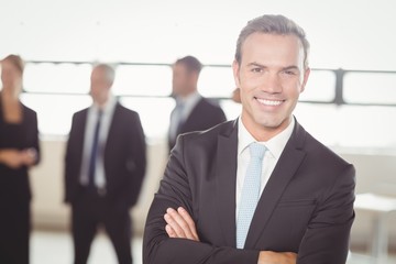 Portrait of young businessman smiling at camera