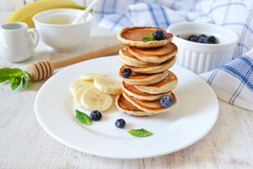 Pancakes for breakfast with honey and blueberries
