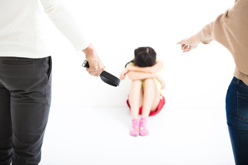 angry  parent and terrified child sitting at wall corner