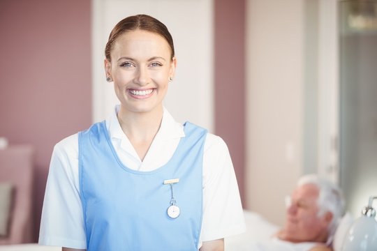 Portrait of happy beautiful nurse at home