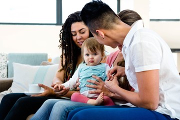 Fototapeta premium three women playing with an adorabl/e baby
