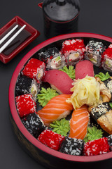 Sushi set with ginger wasabi and chopsticks and soy saue over stone background