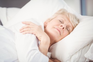 Fototapeta na wymiar Senior woman sleeping on bed