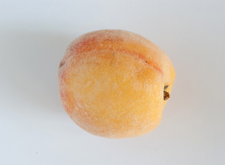Peach fruit. Closeup view on grey background