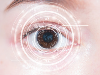 Close-up of woman's brown eye. High technology in the futuristic