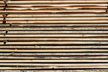Fresh wooden boards stacked to the warehouse. Wood background