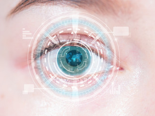 Close-up of woman's blue eye. High technology in the futuristic.
