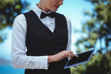Smiling waitress taking an order with a tablet