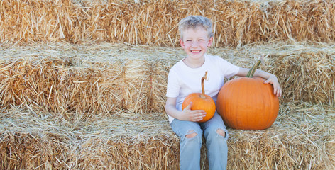 playful kid with pumpkin