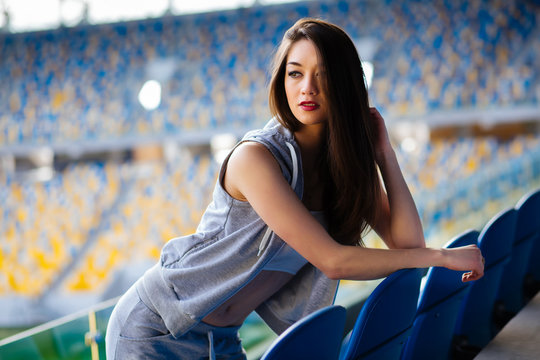 European Young brunette curly teen model creates a concrete stad