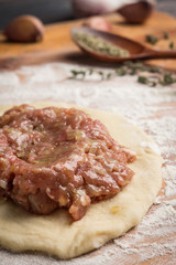 Homemade meat pies on the wooden background