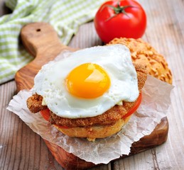 Sandwich with chicken schnitzel, tomato and egg