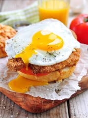 Sandwich with chicken schnitzel, tomato and egg