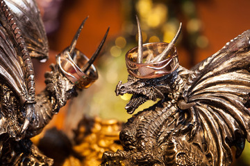 Wedding rings on the heads of dragons