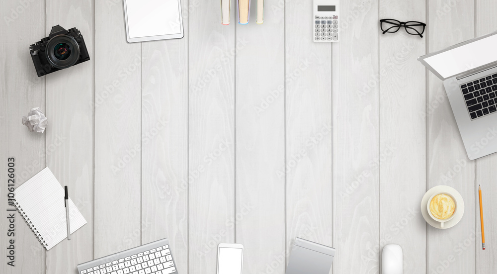 Poster work desk with free space for text surrounded with a lot of desk accessories. there is a laptop, tab