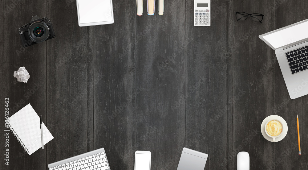 Poster work desk with free space for text surrounded with a lot of desk accessories. there is a laptop, tab