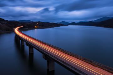 Traffic lights.  Night view of the bridge over the Tzonevo lake, Bulgaria.