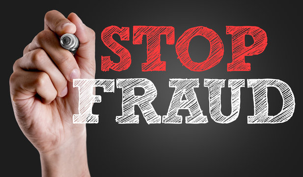 Hand writing the text: Stop Fraud