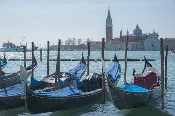 Fototapeta na wymiar Venice with gondolas on Grand Canal against San Giorgio Maggiore church background.