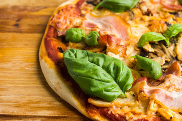 Fresh pizza served on wooden table