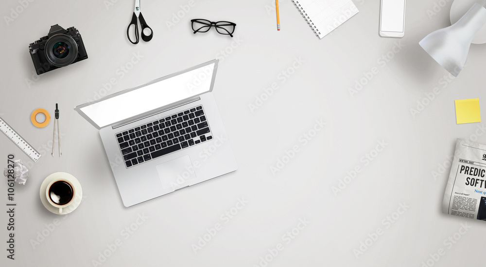 Wall mural work desk with laptop and free space for text surrounded with a lot of desk accessories. there is a 