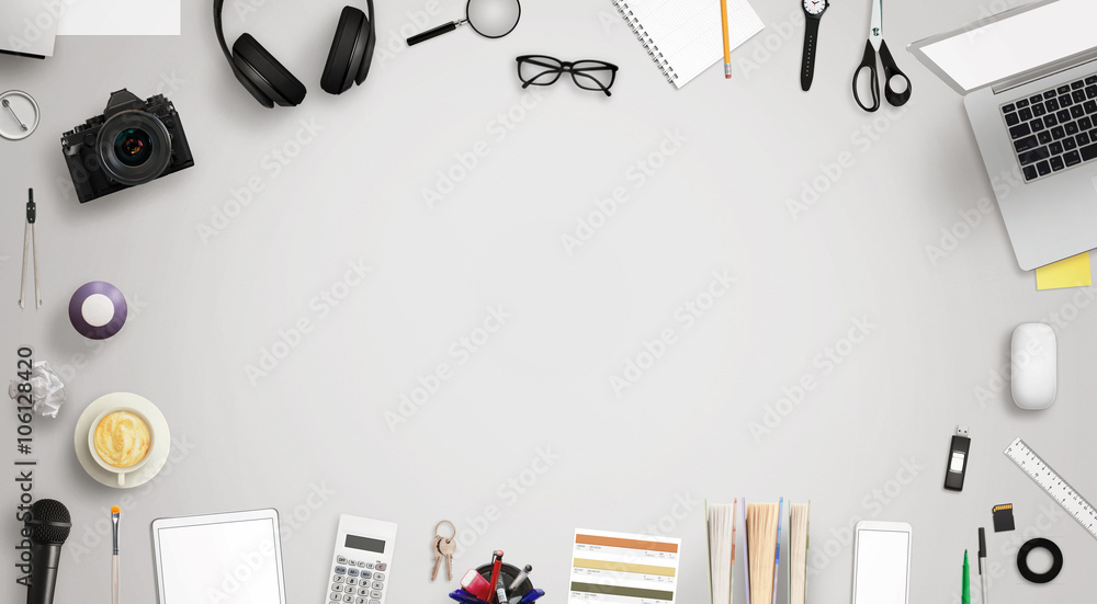 Poster work desk with free space for text surrounded with a lot of desk accessories. there is a laptop, tab