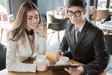 portrait of two business people discussing new project in coffee