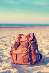 Travel Backpack on Summer Sea Beach. Retro styled.