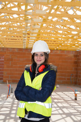 Young woman architect on the building site of construction project