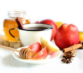 tea, cinnamon, apples, honey and star anise on a white background