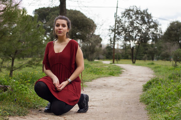 Fashion photo shoot to a young girl in the field in a cloudy day.