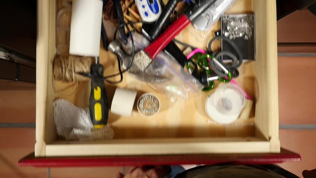 Looking for a flashlight in the junk drawer