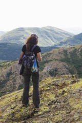 Fototapeta na wymiar Beautiful landscape with young woman in high mountain