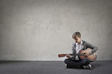 Young boy playing the guitar